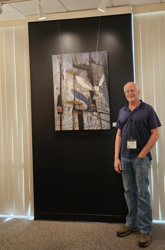 Artist Jim Kaelin next to his painting "Moonshadow"