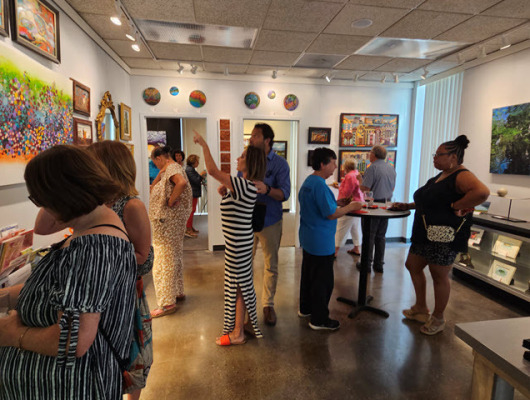 Guests enjoying "A Room with Many Views" exhibit at ARTclectic Gallery