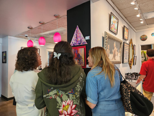 Guests admiring and discussing art at the "Action and Abstraction" opening reception.