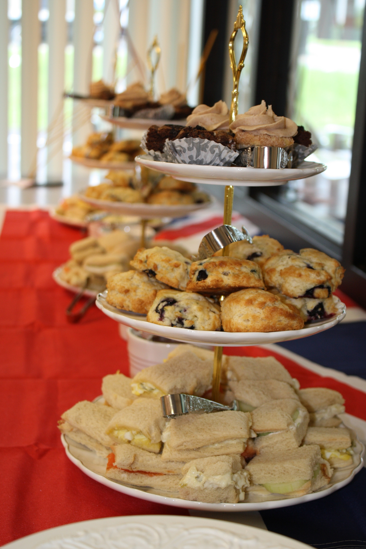 Three tiers of yumminess: a delicious variety of dainty tea sandwiches, scones & sweet treats!